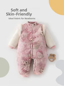 Detail of pink baby romper with traditional Chinese frog buttons and faux fur trim