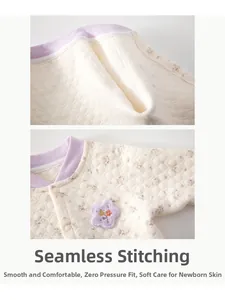 Close-up of baby pajama set showing floral cotton fabric with seamless stitching detail