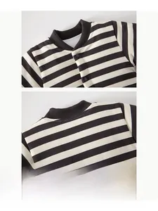 Detail of baby striped cotton romper featuring ribbed neckline and snap button closure