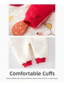 Detail of baby quilted romper showing elastic red ribbed cuffs and dual-thread stitching