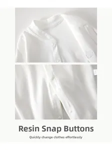Detail of high-quality resin snap buttons on white organic cotton baby bodysuit
