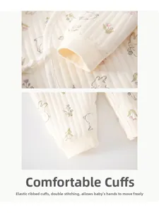 Detail of infant romper showing elastic ribbed cuffs and cute bunny tulip patterns