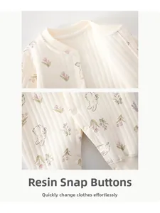 Detailed close-up of eco-friendly resin snaps on a floral ribbed baby romper