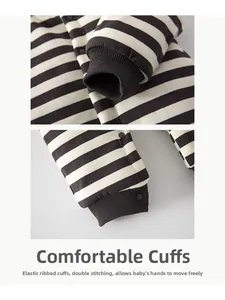 Macro detail of elastic ribbed cuffs and black-white striped fabric on baby padded romper