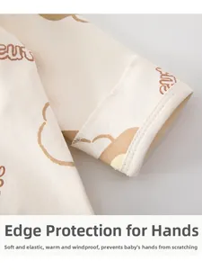 Detail of baby cotton top featuring anti-scratch cuffs and cute bear prints