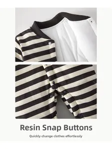 Detail of baby striped romper featuring durable resin snap buttons and a ribbed collar
