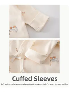 Detail of baby cotton top featuring protective turnover mittens to prevent scratching