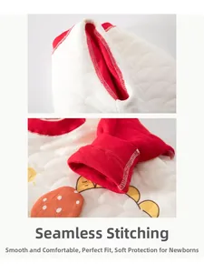Detail of boneless stitching on padded baby romper with red trim and dinosaur print