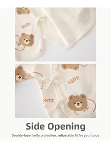 Detail of baby side-opening bodysuit featuring cute bear print and secure tie closures
