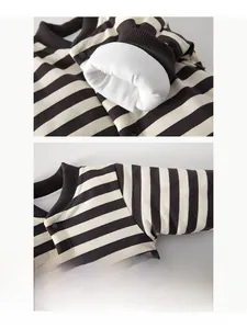 Detailed macro view of striped baby bodysuit showing flatlock seams and ribbed cuffs