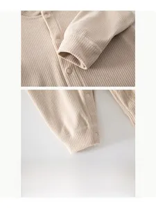 Close-up of ribbed cuffs and high-quality snap buttons on infant thermal jumpsuit