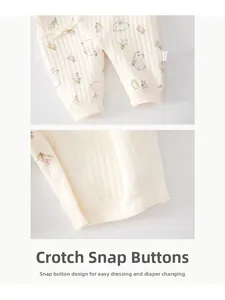 Detail of snap button crotch on cream ribbed baby romper with pink flower and bunny print
