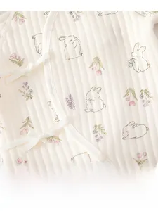 Detail of baby romper featuring rib-knit cotton fabric with cute rabbit and flower prints