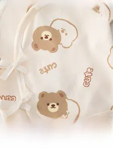 Macro detail of newborn cotton kimono top with bear print and side tie fastening