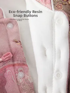 Macro detail of eco-friendly resin snap buttons on pink floral jacquard baby cotton coat