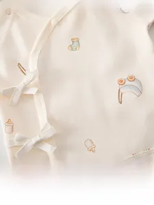 Detail of baby cotton tie-front shirt featuring cute rainbow and cartoon prints