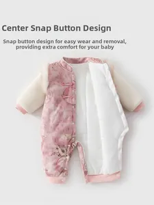 Detail view of pink baby romper with traditional Chinese floral prints and snap closures
