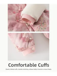 Detail of pink floral baby winter suit with golden embroidery and elastic ribbed cuffs