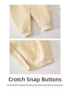 Detail of baby romper snap closure for easy diaper changes and quilted star patterns