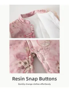 Detail of pink floral baby winter romper showing warm plush lining and resin snap buttons