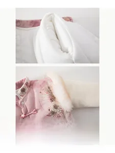Detail of baby pink padded romper with traditional embroidery and soft fleece collar