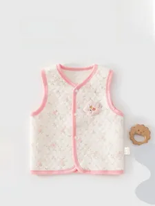 Close-up of baby floral quilted vest with hexagonal pattern and soft cotton texture