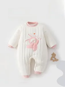 Detail view of quilted baby romper with pink rabbit embroidery and snap closure
