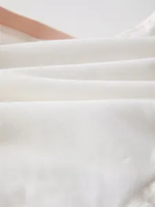 Détail de la texture en coton blanc doux avec tissage respirant pour vêtements bébé