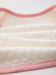 Macro shot of breathable honeycomb quilted soft fine cotton fabric for baby vest