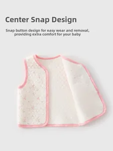 Detail of baby quilted vest featuring snap buttons and hexagonal honeycomb texture