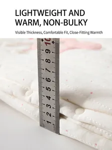 Thick padded white quilted baby romper featuring pink polka dots for winter warmth