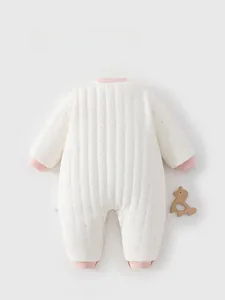 Detail view of the quilted back of the baby romper with pink polka dots and ribbed cuffs
