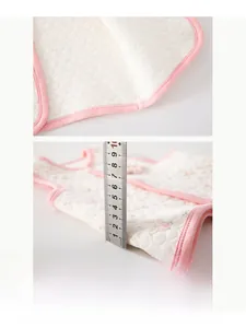 Detail view of quilted cotton baby vest fabric texture and thickness measurement