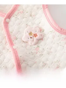 Close-up of pink floral quilted baby vest with 3D flower embroidery and resin buttons