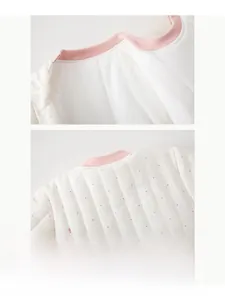 Macro detail of the soft quilted fabric collar with pink dots for baby winter warm jumpsuit