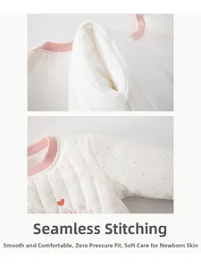 Close-up of padded baby romper with pink polka dots and smooth boneless sewing detail