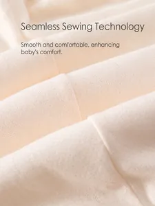 Detailed view of seamless stitching on a beige padded baby cotton bodysuit
