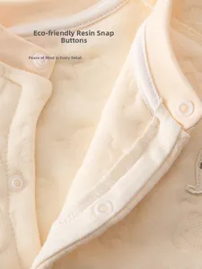 Close-up of baby quilted bodysuit featuring eco-friendly resin snaps and warm fabric