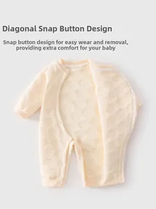 Detail of baby quilted romper featuring snap buttons and textured animal patterns