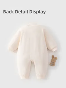 Back view of a baby's soft cotton padded romper with ribbed cuffs and a wooden rattle