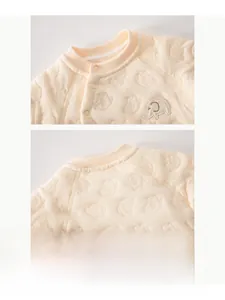 Detail of baby quilted bodysuit neckline with snap buttons and elephant embroidery