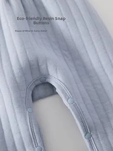 Detail of eco-friendly resin snap buttons on light blue ribbed baby winter trousers