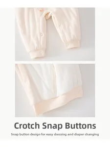 Detail view of crotch snap buttons on cotton baby romper for easy diaper changes