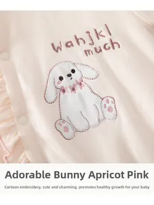 Detailed view of apricot pink baby romper with cute rabbit embroidery and side ruffles