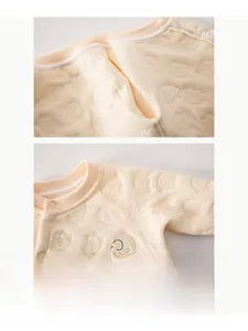 Detail of baby quilted romper showing soft seamless stitching and embroidered elephant patch