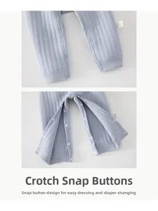 Detailed view of snap fasteners on baby blue ribbed pants for easy diaper changes