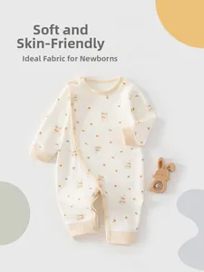 Detail view of cotton newborn romper with floral bunny print and side snap buttons