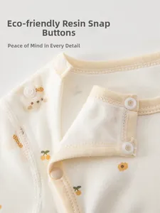 Detail of eco-friendly resin snap buttons on a cute floral cotton baby bodysuit