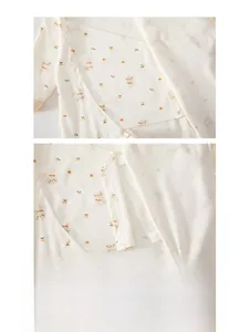 Detail view of cotton baby romper featuring a double-layer belly guard and bear print