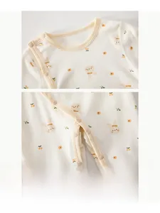 Close-up of resin snap buttons on cotton baby bodysuit with cute rabbit and flower prints